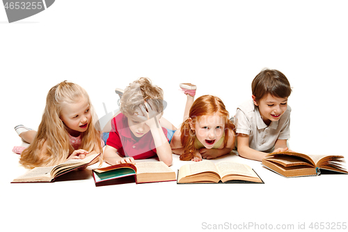 Image of The kids boy and girls laying with books isolated on white