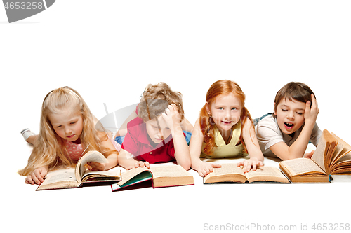Image of The kids boy and girls laying with books isolated on white