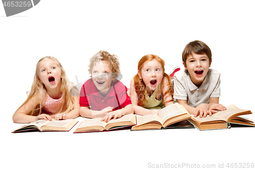 Image of The kids boy and girls laying with books isolated on white