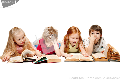 Image of The kids boy and girls laying with books isolated on white