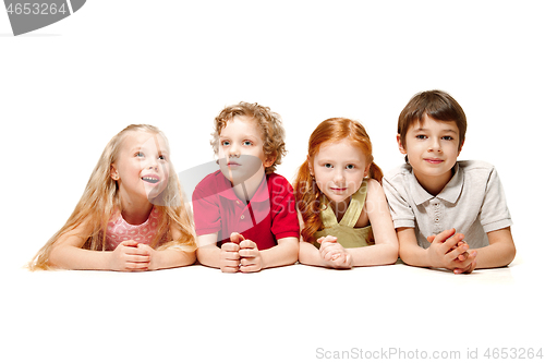 Image of Close-up of happy children lying on floor in studio and looking up, isolated on white background