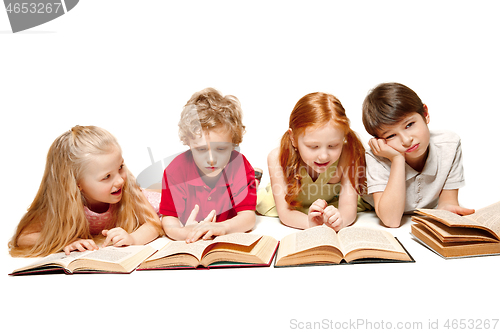 Image of The kids boy and girls laying with books isolated on white