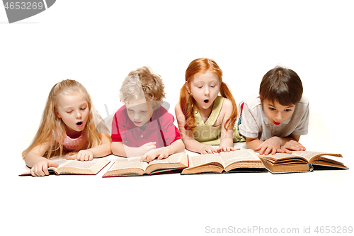 Image of The kids boy and girls laying with books isolated on white