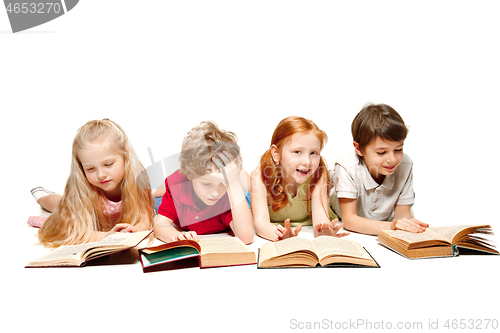 Image of The kids boy and girls laying with books isolated on white