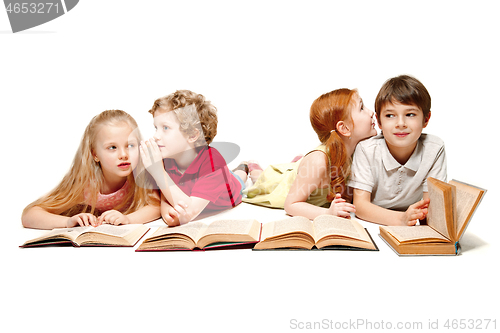 Image of The kids boy and girls laying with books isolated on white