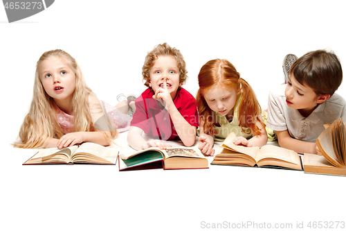 Image of The kids boy and girls laying with books isolated on white