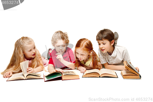 Image of The kids boy and girls laying with books isolated on white