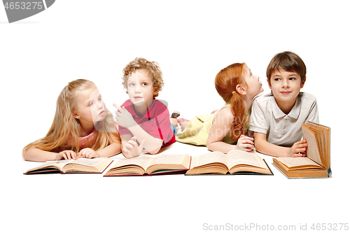 Image of The kids boy and girls laying with books isolated on white