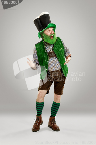 Image of A man in a leprechaun hat at studio. He celebrates St. Patrick\'s Day.