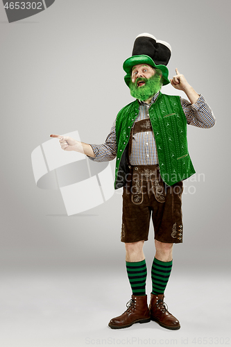 Image of A man in a leprechaun hat at studio. He celebrates St. Patrick\'s Day.