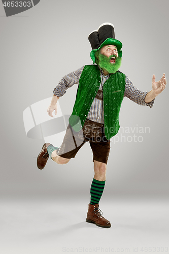 Image of A man in a leprechaun hat at studio. He celebrates St. Patrick\'s Day.