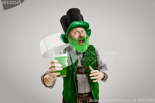 Image of A man in a leprechaun hat at studio. He celebrates St. Patrick\'s Day.