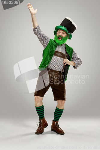 Image of A man in a leprechaun hat at studio. He celebrates St. Patrick\'s Day.