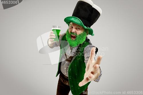 Image of A man in a leprechaun hat at studio. He celebrates St. Patrick\'s Day.