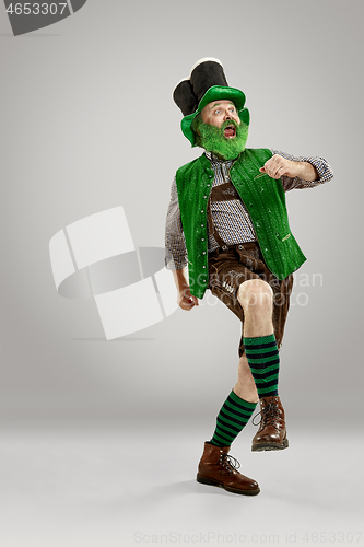 Image of A man in a leprechaun hat at studio. He celebrates St. Patrick\'s Day.