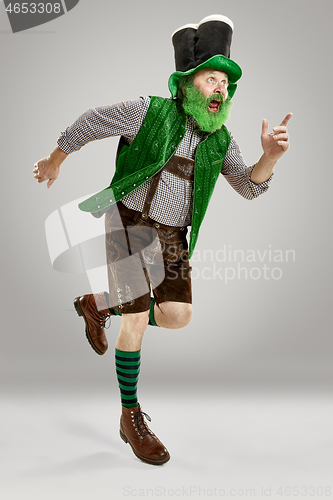 Image of A man in a leprechaun hat at studio. He celebrates St. Patrick\'s Day.