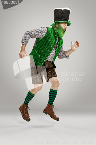 Image of A man in a leprechaun hat at studio. He celebrates St. Patrick\'s Day.