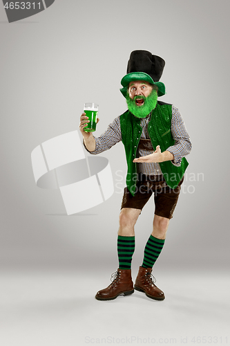 Image of A man in a leprechaun hat at studio. He celebrates St. Patrick\'s Day.