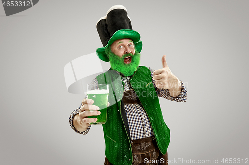 Image of A man in a leprechaun hat at studio. He celebrates St. Patrick\'s Day.