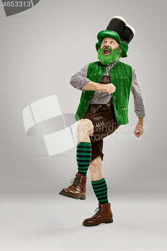 Image of A man in a leprechaun hat at studio. He celebrates St. Patrick\'s Day.