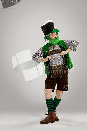 Image of A man in a leprechaun hat at studio. He celebrates St. Patrick\'s Day.