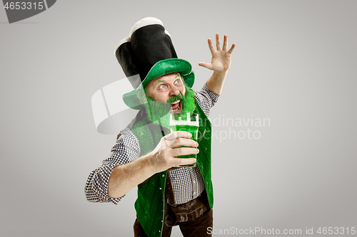 Image of A man in a leprechaun hat at studio. He celebrates St. Patrick\'s Day.