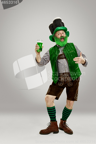 Image of A man in a leprechaun hat at studio. He celebrates St. Patrick\'s Day.