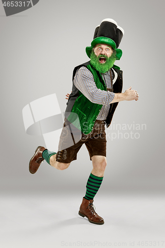 Image of A man in a leprechaun hat at studio. He celebrates St. Patrick\'s Day.