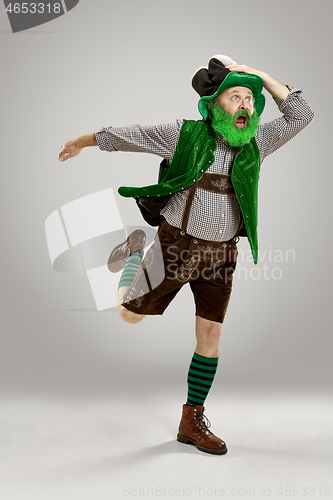 Image of A man in a leprechaun hat at studio. He celebrates St. Patrick\'s Day.