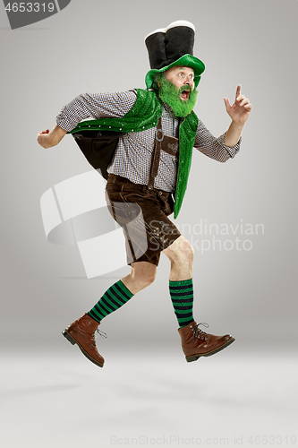 Image of A man in a leprechaun hat at studio. He celebrates St. Patrick\'s Day.