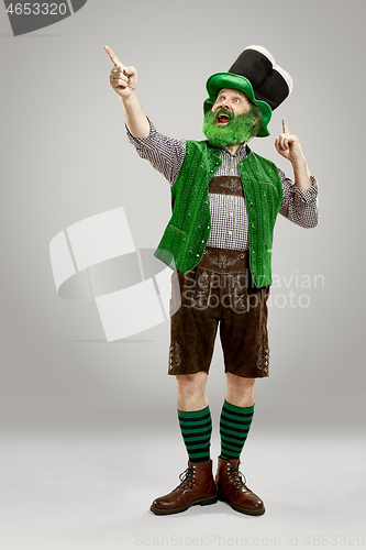 Image of A man in a leprechaun hat at studio. He celebrates St. Patrick\'s Day.