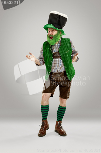 Image of A man in a leprechaun hat at studio. He celebrates St. Patrick\'s Day.