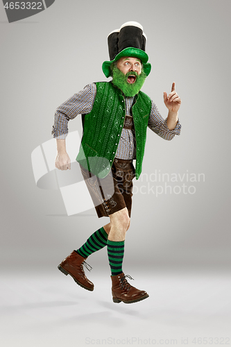 Image of A man in a leprechaun hat at studio. He celebrates St. Patrick\'s Day.