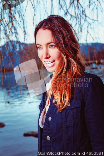 Image of Portrait of a young brunette woman at the lake