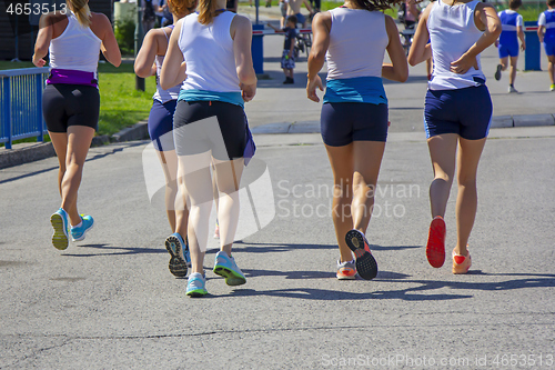 Image of Group Young girls friends running on the city street