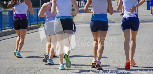 Image of Group Young girls friends running on the city street