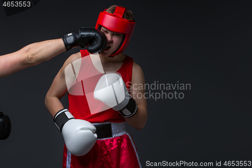 Image of young boxer is being punched