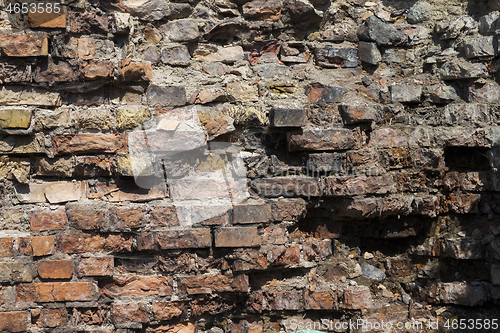 Image of Part of the destroyed brick wall close-up