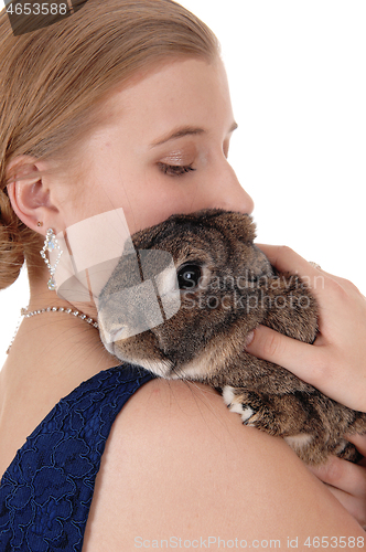 Image of Young woman holding a rabbit on her shoulder