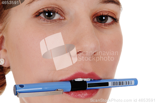 Image of Closeup of woman's face with pen