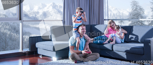 Image of Happy family playing a video game