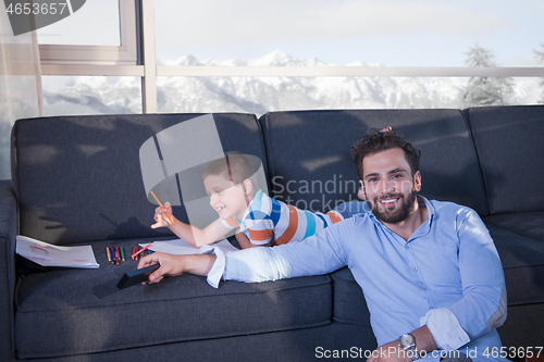 Image of Happy Young Family Playing Together on sofa