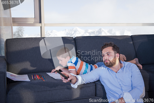 Image of Happy Young Family Playing Together on sofa