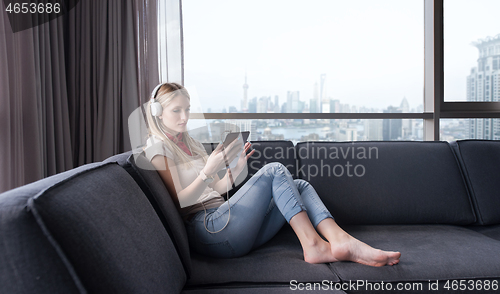 Image of young girl enjoying music through headphones