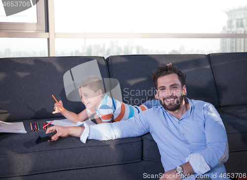 Image of Happy Young Family Playing Together on sofa