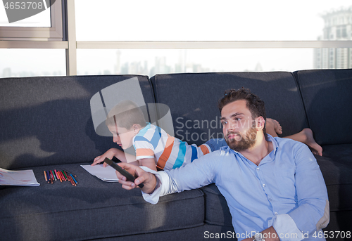 Image of Happy Young Family Playing Together on sofa