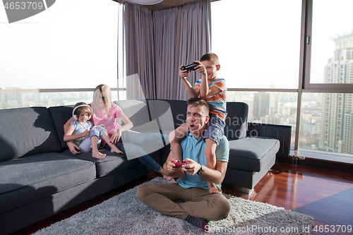 Image of Happy family playing a video game