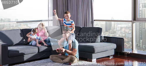 Image of Happy family playing a video game