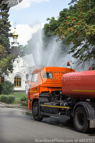 Image of Work watering machine in city public park