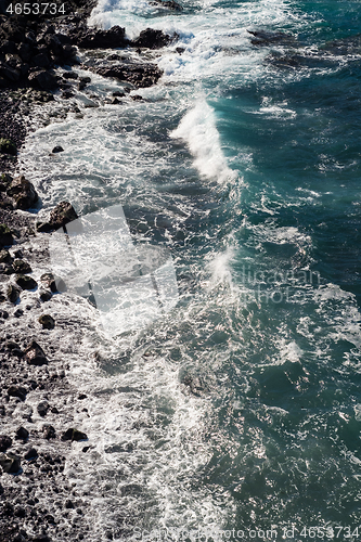 Image of beautiful view on ocean water and black lava sand